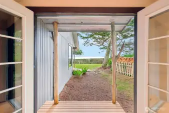 French doors open to private patio - notice the unique tree trunk style posts.