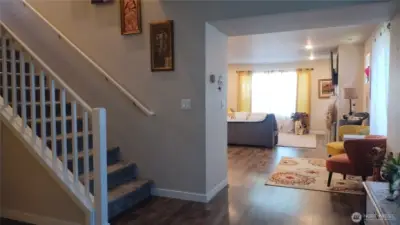 The front entry is very wide and the 5th bedroom is to the left near the staircase.