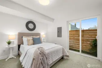 This guest bedroom opens to a private fenced patio—perfect for indoor-outdoor living.
