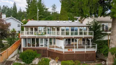 Beautiful back of the home highlighting all of the view windows and deck space!