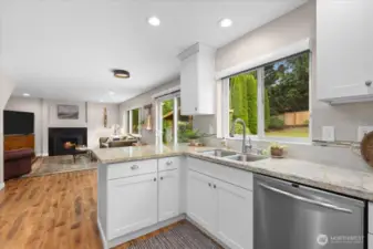 Beautiful, sun-drenched kitchen and living room. Neutral granite counters will flow with any decor!