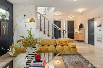 Looking back toward the front entry, you'll find the garage access to the right and the entrance to the main-level bedroom on the left. This floor also features a beautifully remodeled three-quarter bathroom—perfect for guests and everyday convenience alike!