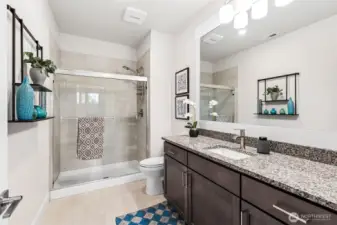 Spacious guest bath with 70" vantey, walk-in shower with glass doors and comfort height comode!  Convenient to both of the secondary bedrooms