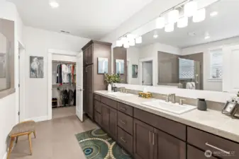Double vanity offers additional cabinets and storage.  Also the large wall to wall mirror adds depth and brightness to the space.  Walk in closet is adjacent and convenient to the bathroom.