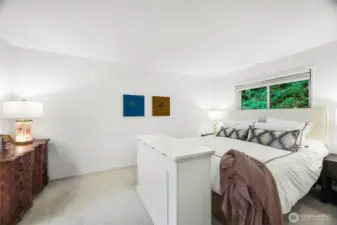 primary bedroom faces the greenbelt behind the building. Walk in closet with built in system.