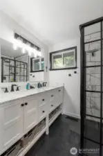Gorgeous updated En-suite bathroom offers dual vanities and a stylish glass shower.
