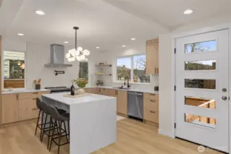 Stainless steel, quartz waterfall island, wall of storage, all the modern features you have been seeking