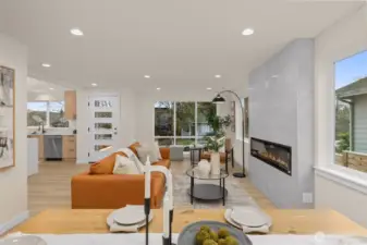 The living room features a statement electric fireplace. Masterfully crafted ceramic tile surrounds building a pristine atmosphere