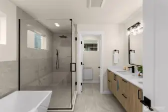 Primary bath features the same level of detail and craftsmanship as the rest of the home. Full tile surround shower with full glass entry & wall. Standalone tub, & separated room for the toilet