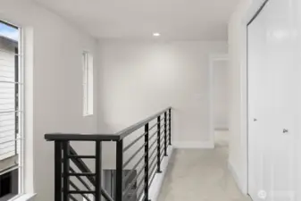 The staircase leads gracefully up to the bedrooms, creating a natural separation between living spaces and private areas.