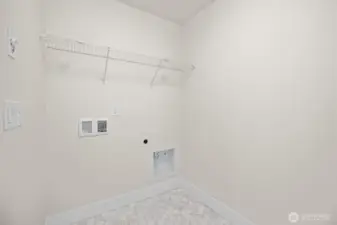 The utility room is located on the upper level between the bedrooms.