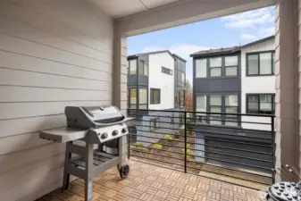 The cozy deck is perfectly set up for summer entertaining, complete with a gas hookup ready for BBQs.