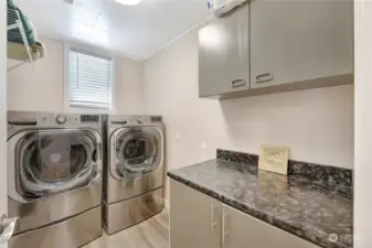 Laundry room with new pedestal LG washer and dryerand lots of storage.
