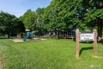 Situated adjacent to a park with a play area and basketball court.