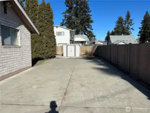 Large parking pad with a storage shed