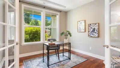 A view of the den reveals a warm, inviting space that feels tucked away yet totally connected. With its French doors, flexible layout, and just-right placement near the entry, it’s ready for work, relaxation, or welcoming your favorite guests.