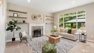 At the back of the main level, you’ll find a wow-worthy living space that’s equal parts cozy and open. A gas fireplace adds warmth and ambiance, while huge windows frame peaceful backyard views - bringing the outdoors in and making this the perfect spot to gather, relax, or unwind.