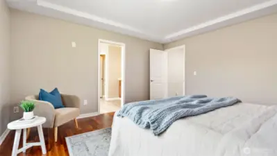 The tray ceiling adds just the right touch of architectural interest, giving the primary suite a feeling of quiet sophistication. Just beyond, the doorway leads into the ensuite - your own private escape, ready for relaxation and comfort