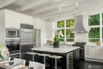 Gourmet kitchen with a  sleek Calacatta marble island,quartz countertops and luxury stainless-steel appliances