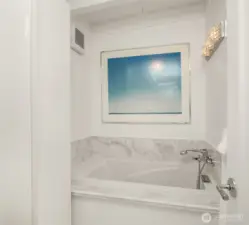 The primary bathroom features a luxurious soaking tub