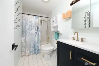 Nicely updated main bathroom with tile flooring and quartz counters