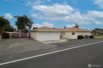 Here is side view of property showing RV boat and extra car parking next to garage