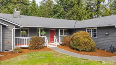 Enjoy this charming setting with exposed aggregate pathways and a covered front deck  .
