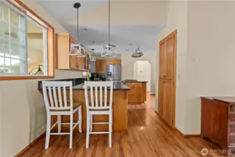 Breakfast bar and a large pantry cabinets to the right.
