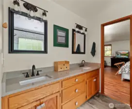 Completely remodeled en-suite, with solid surface countertops, dual sink vanity, tiled flooring and solid wood cabinets.