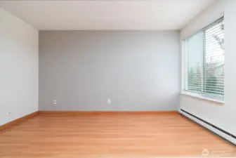 Spacious primary bedroom filled with beautiful natural light.