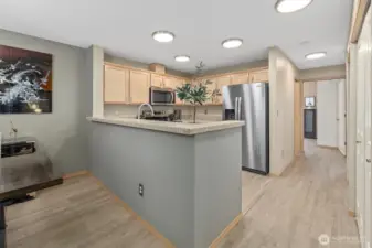 Kitchen with high eating bar, brand new stove and fridge.