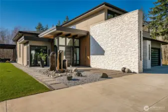 Exterior custom water feature and front entryway.
