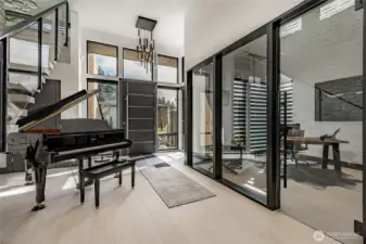 Entryway with floor to ceiling glassed-in office.