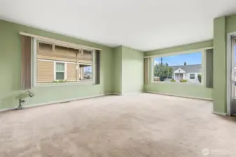 Huge windows emit incredible light in the main unit living / dining room