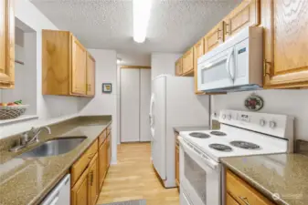Kitchen features granite counter tops and updated appliances