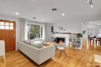 Gleaming hardwood floors  with wood burning fireplace in the living room.