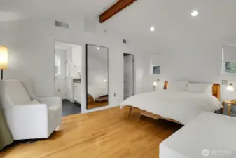 The primary bedroom is on the main level and features high vaulted ceilings, a huge walk-in closet, and an en-suite full bathroom.