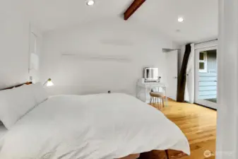 The primary bedroom has access to the level fenced backyard through the double French doors.