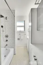 Beautiful subway tile with ample storage in the hall bath.