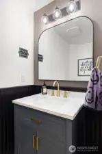 The half bath was redone in 2023 and is so chic.