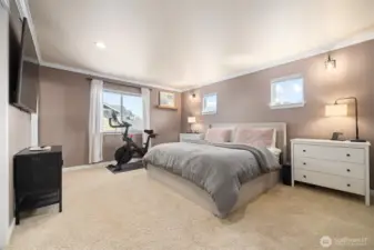 The primary suite is very spacious and has crown molding.