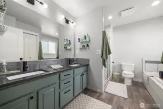 The primary bathroom has a very large dual sink vanity and a separate shower and soaking tub.