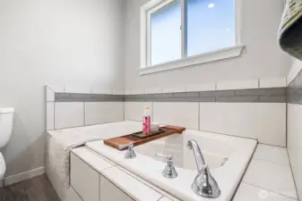 There is a deep soaking tub in the primary bath.