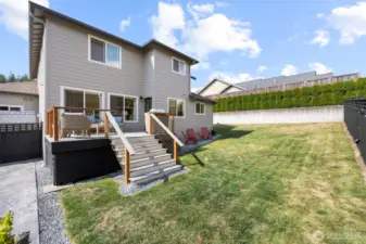Another view of the rear yard and spacious deck that is off the kitchen and family room area.