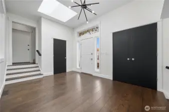Foyer  Stylish front foyer featuring modern lighting, double closets, and a skylight that fills the space with natural light.