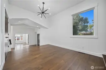 Entry / Foyer -   Bright, open entry with sleek hardwood floors, vaulted ceilings, and direct sightlines through to the main living area.