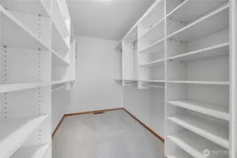 Primary Bedroom #2 (Walk-In Closet) -   Expansive walk-in closet with custom built-in shelving and abundant storage options — a dream setup for organizing clothing, shoes, and accessories.