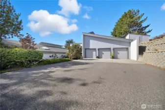 3-Car Attached Garage -   Spacious three-car garage with ample driveway parking, clean modern exterior, and easy access to the home’s entry and main level.