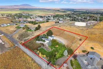 Expansive drone perspective highlighting the full 2.5-acre property, scenic hillside location, and panoramic territorial views.