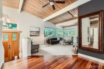Upon entry, you'll notice the tall ceilings and exposed beams give the home an airy, contemporary feel